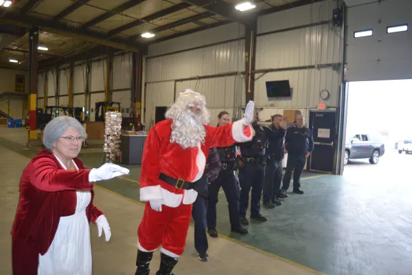 Santa greets party goers along with Normal Police & Fire Department personnel