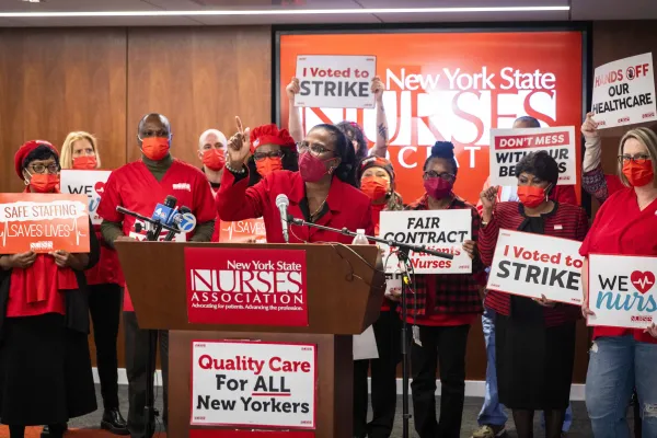 Nancy Hagans at podium surrounded by NYSNA nurses