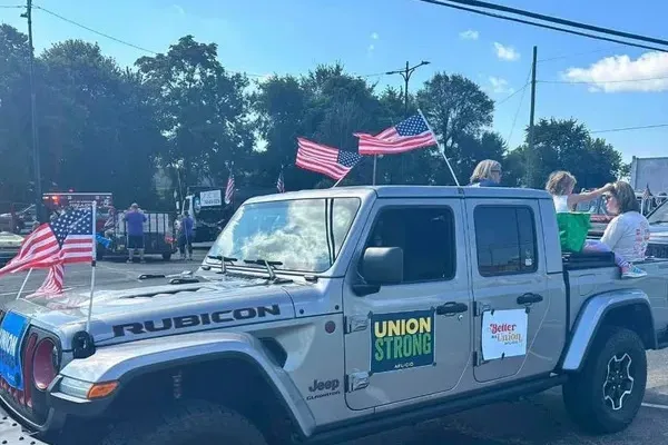 A gray Jeep driving in a parade, with a sign stating: "UNION STRONG"