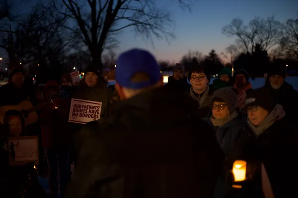 Photo of a group of people at a candle light Vigil for Alex Pretti