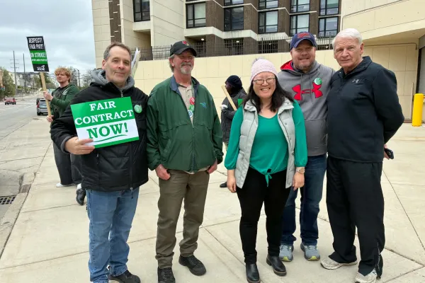 Union Solidarity: Jerry Kelleher, United Association Local 99, Chuck Carver, AFSCME Local 1110 President, State Representative Sharon Chung (American Federation of Musicians member), Matt Strupp, IBEW Local 197 President, and John Penn, retired LIUNA Local 362, stand with striking AFSCME 1110 workers at Illinois State University on April 10.