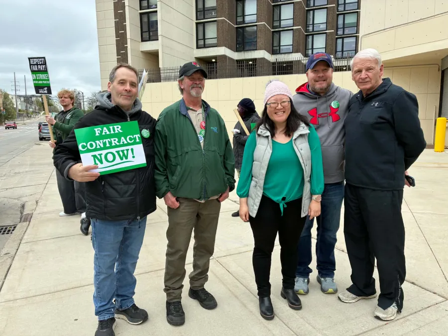 Union Solidarity: Jerry Kelleher, United Association Local 99, Chuck Carver, AFSCME Local 1110 President, State Representative Sharon Chung (American Federation of Musicians member), Matt Strupp, IBEW Local 197 President, and John Penn, retired LIUNA Local 362, stand with striking AFSCME 1110 workers at Illinois State University on April 10.