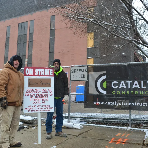 United Association Local 99 members Jerry Kelleher and Chip Givens protest Catalyst Constrution's use of non-union, out of town contrator Paluska Plumbing on the C II East building renovation downtown.