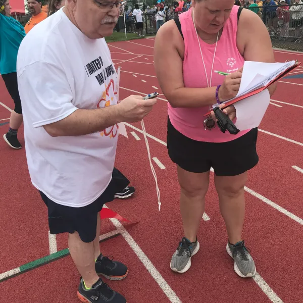 Sean Fagan, Steelworkers 787, checks times at Illinois Special Olympics 2024 state games